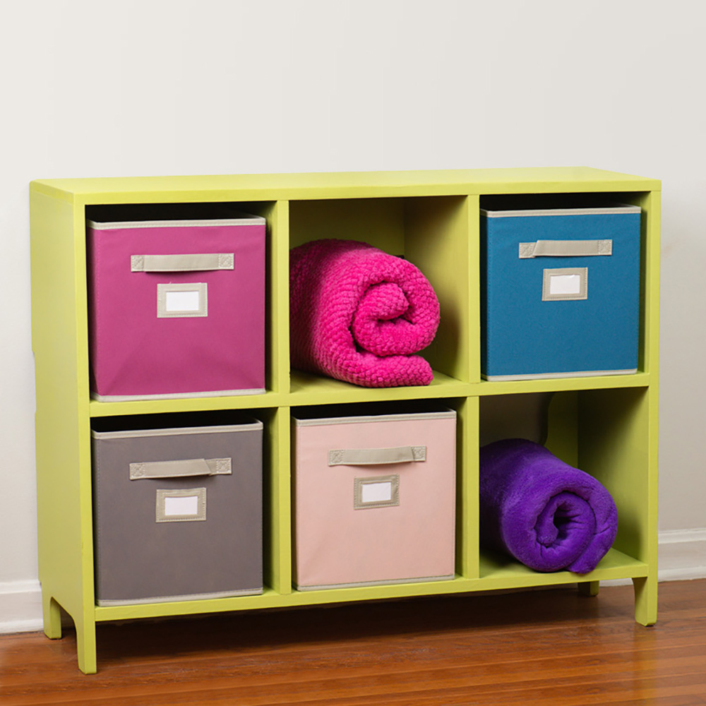 A kids cubby storage unit with added cloth bins and blankets.
