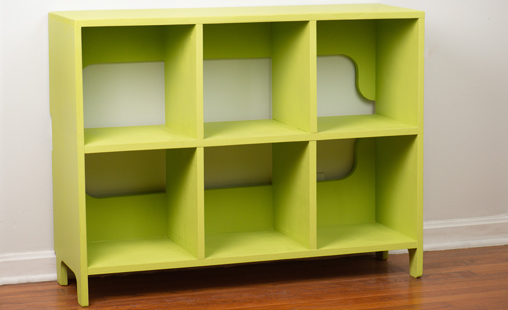 A finished kids cubby storage unit painted green.