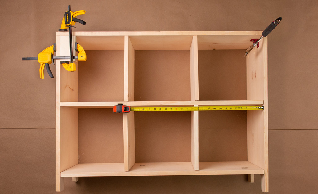 A cubby storage clamped together to dry fit the boards.