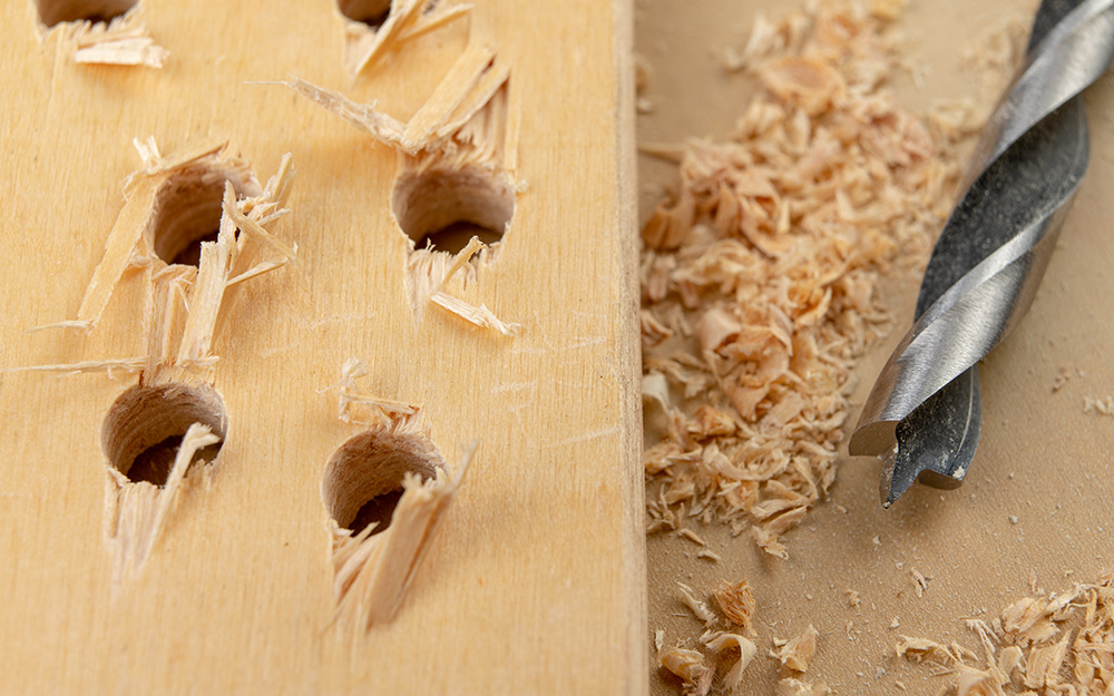 holes drilled in a wooden board holes drilled in a wooden board