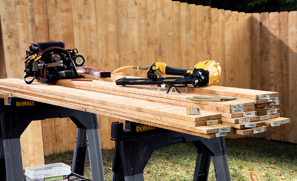 Lumber and tools gathered for building a picnic table.