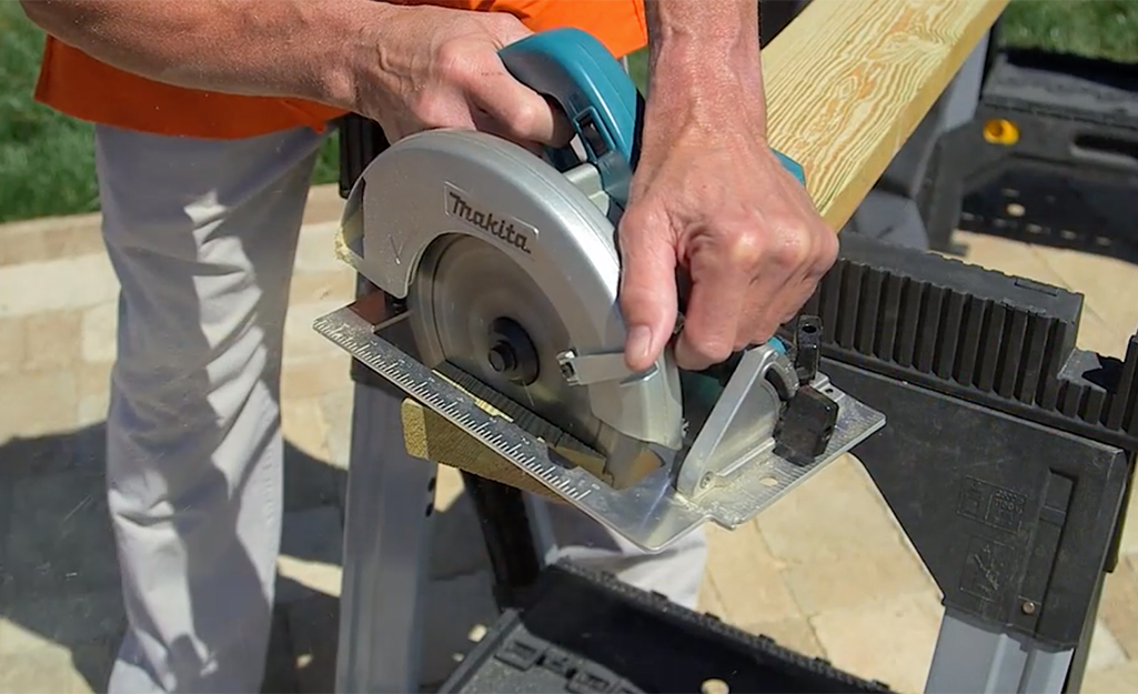 Someone cutting off a table leg with a circular saw. Someone cutting off a table leg with a circular saw.