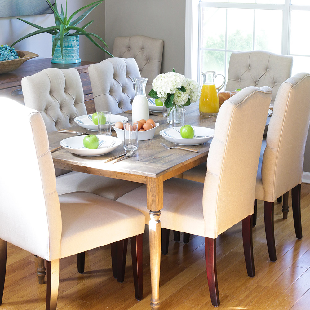 A dining room with a rustic farmhouse dining table.