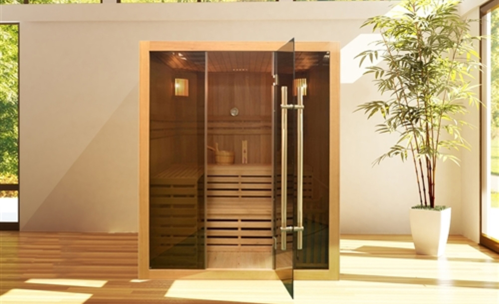 A wood sauna with a glass door.