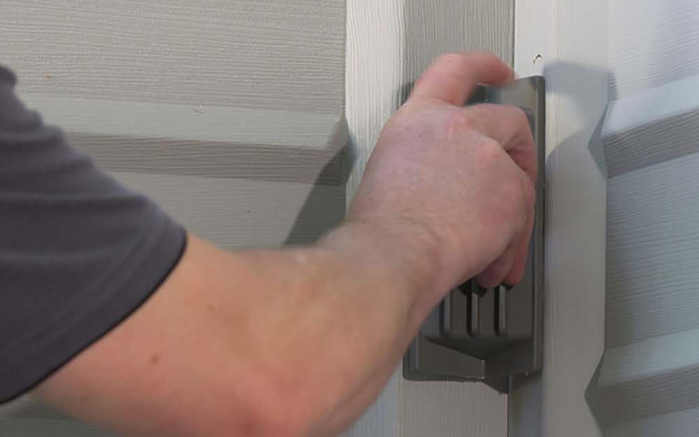 A man locks in the corner of a DIY shed. A man locks in the corner of a DIY shed.
