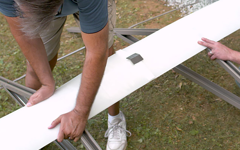 Two men working on the trusses for the shed's roof. Two men working on the trusses for the shed's roof.