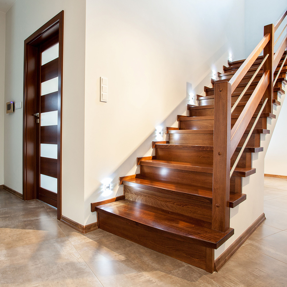 A wood staircase installed in a foyer.