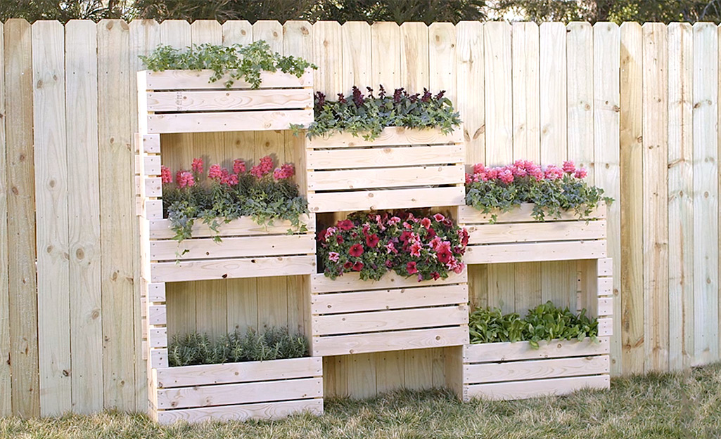 DIY vertical garden filled with herbs, flower and other plants.