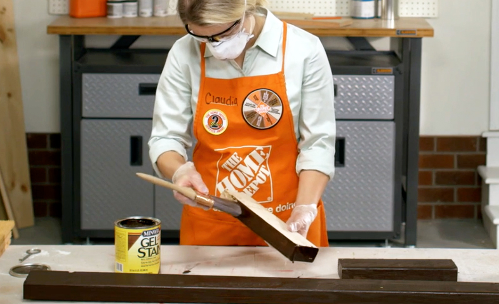 DIY-er applying stain to lumber