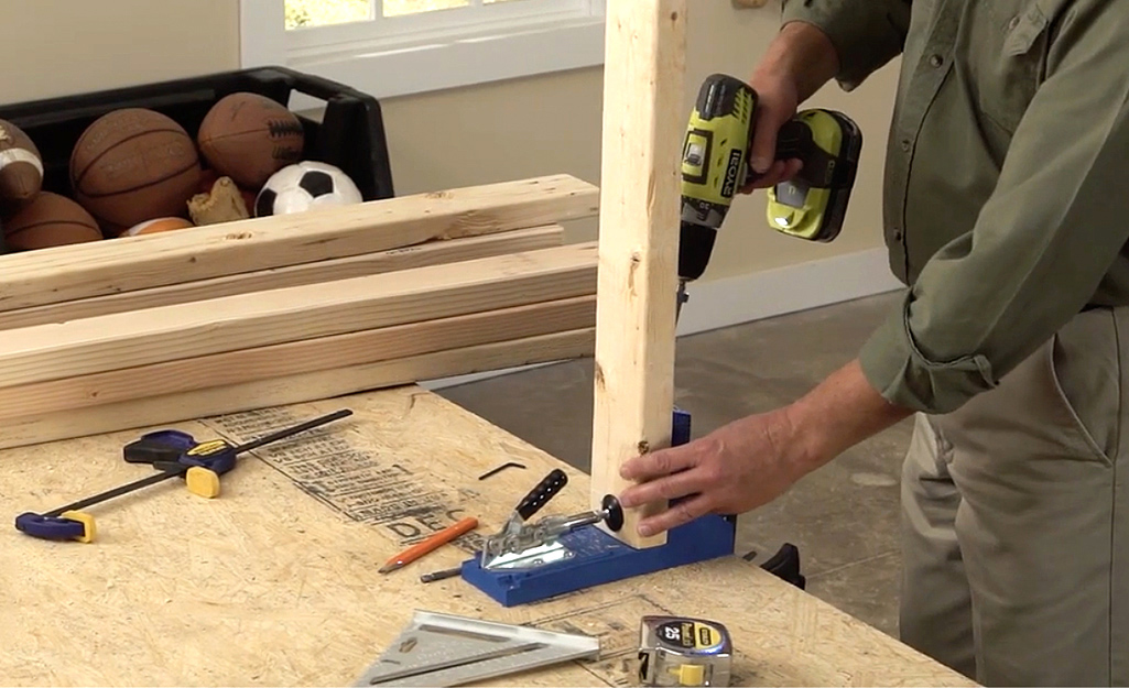 A man drills pilot holes A man drills pilot holes