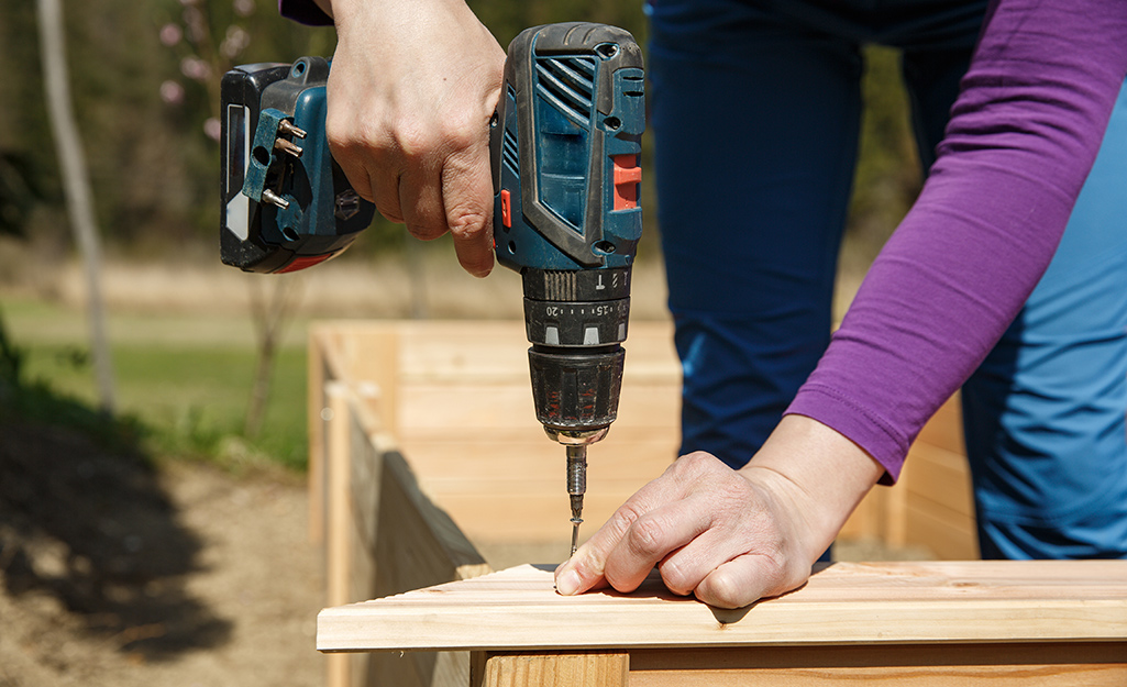 DIY-er drills screw into board