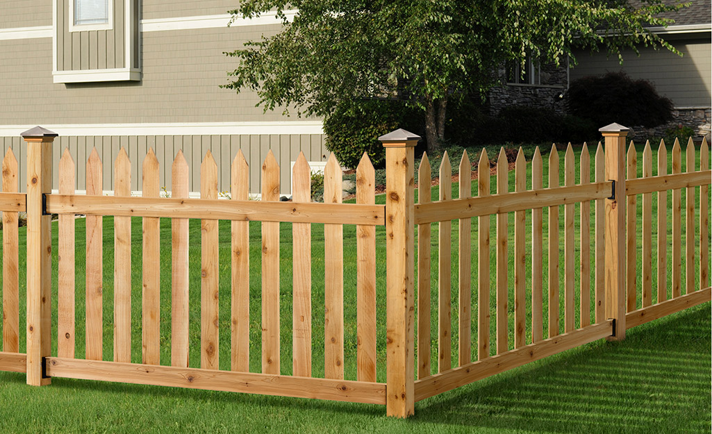 A wood fence installed in a yard.