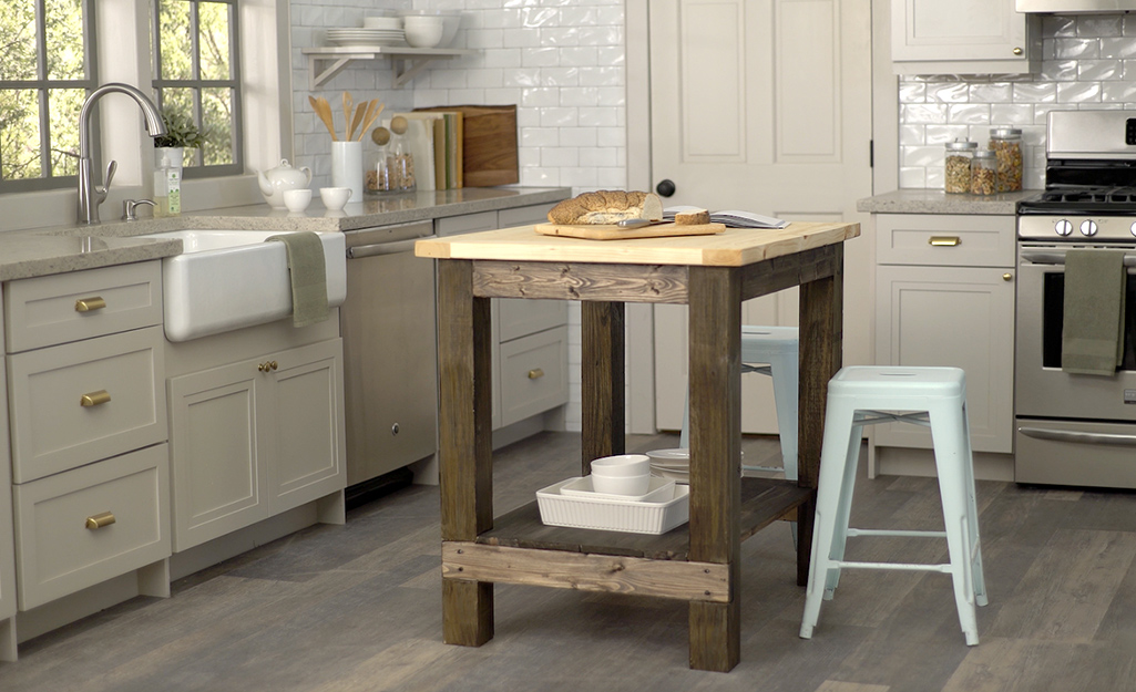 A DIY kitchen island placed across from a kitchen sink.