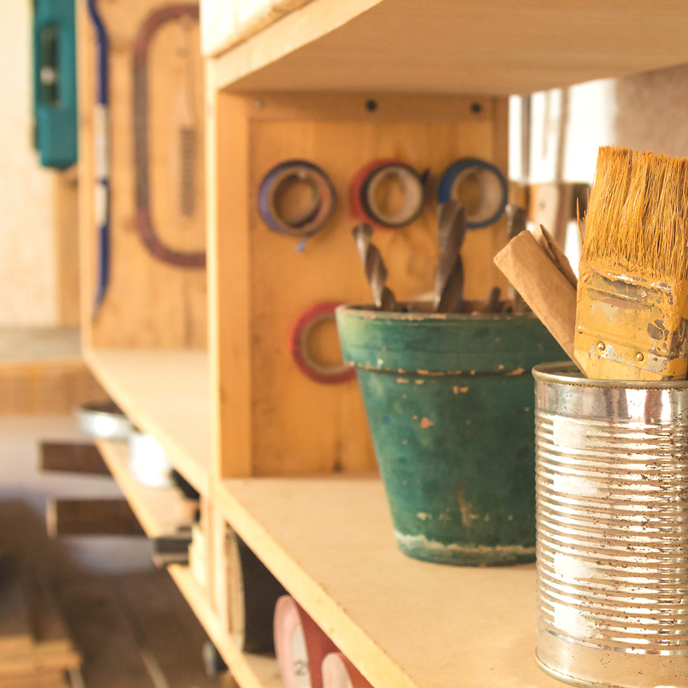 A utility shelf with tools and workshop materials. A utility shelf with tools and workshop materials.