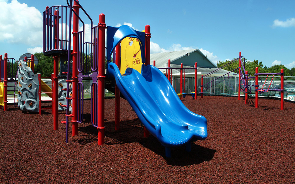 A children's playground that uses playground mulch as a groundcovering.