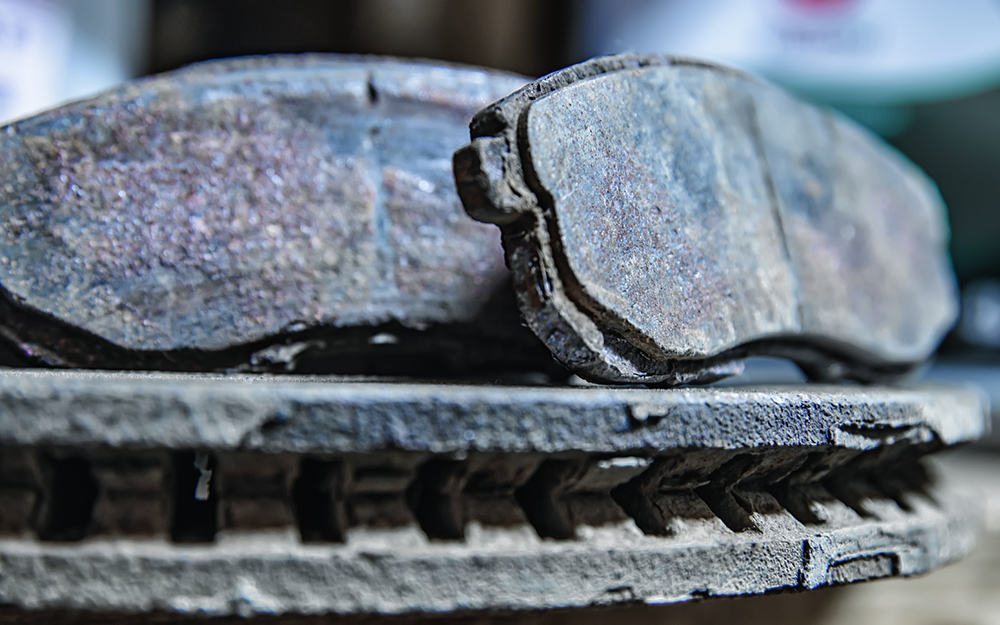 A close up of worn brake pads