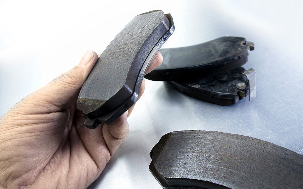 A person holds an assembled brake pad.