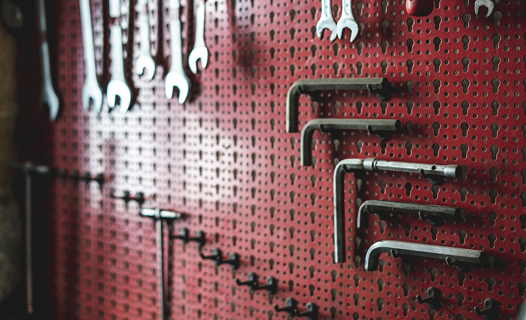 Tools on a pegboard in a garage. 