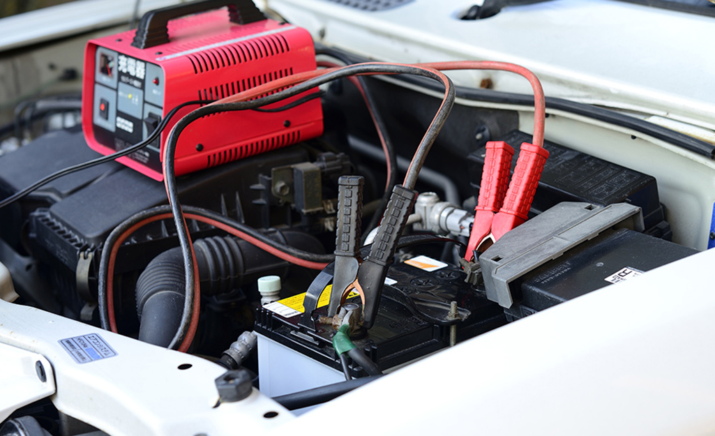 A car battery charger connected to a car battery