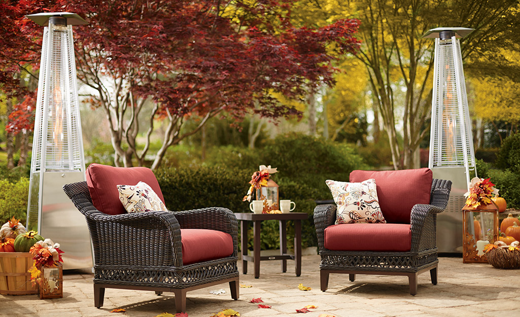 Patio heaters in an autumn setting with patio furniture