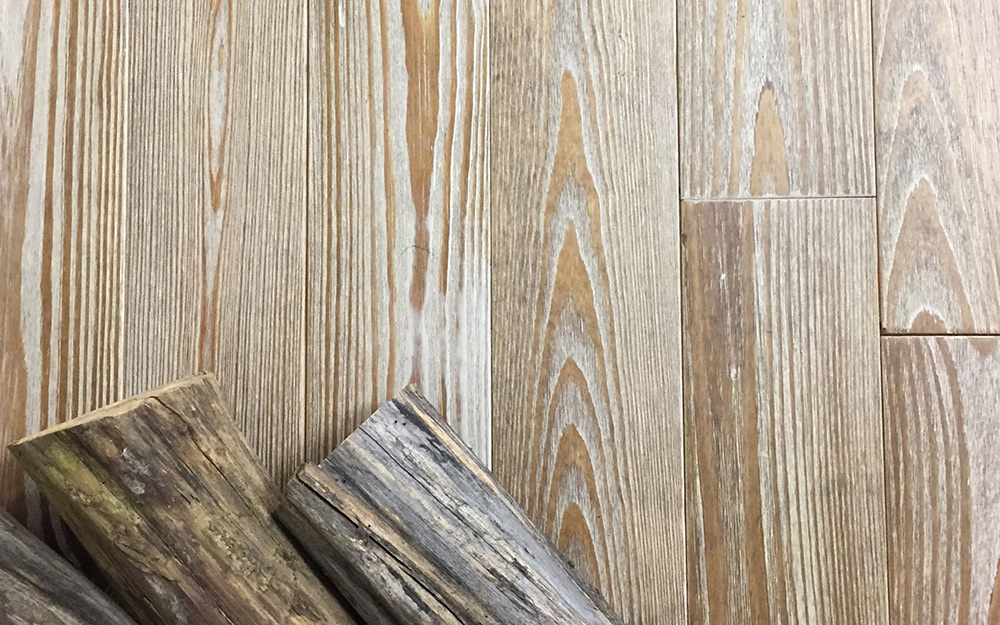 Logs lying on top of wood flooring.