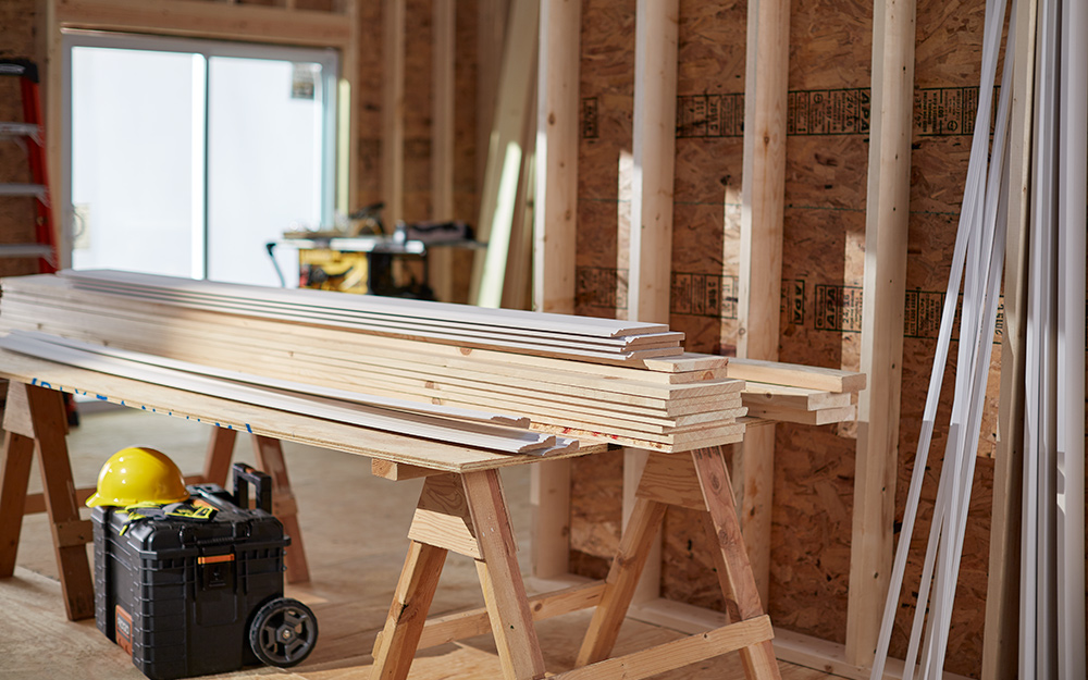 Lumber sits in a construction site. 