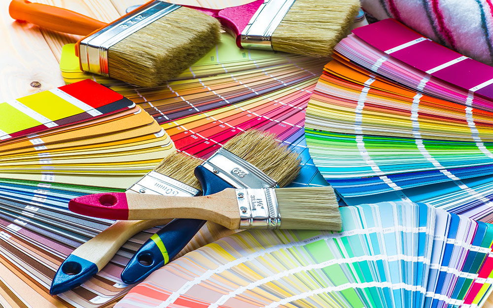 Different paint brushes displayed with colorful paint chips.