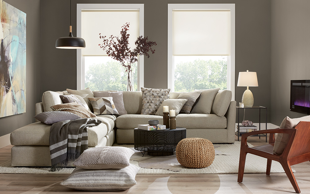 A neutral monochromatic living room filled with beige and tan furniture.