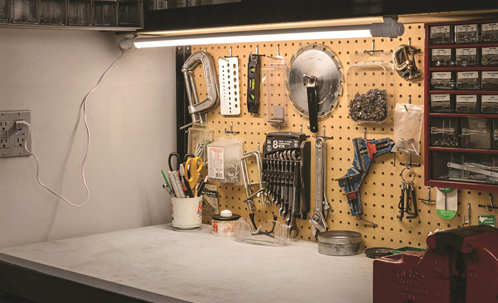 A shop light over a garage work space.