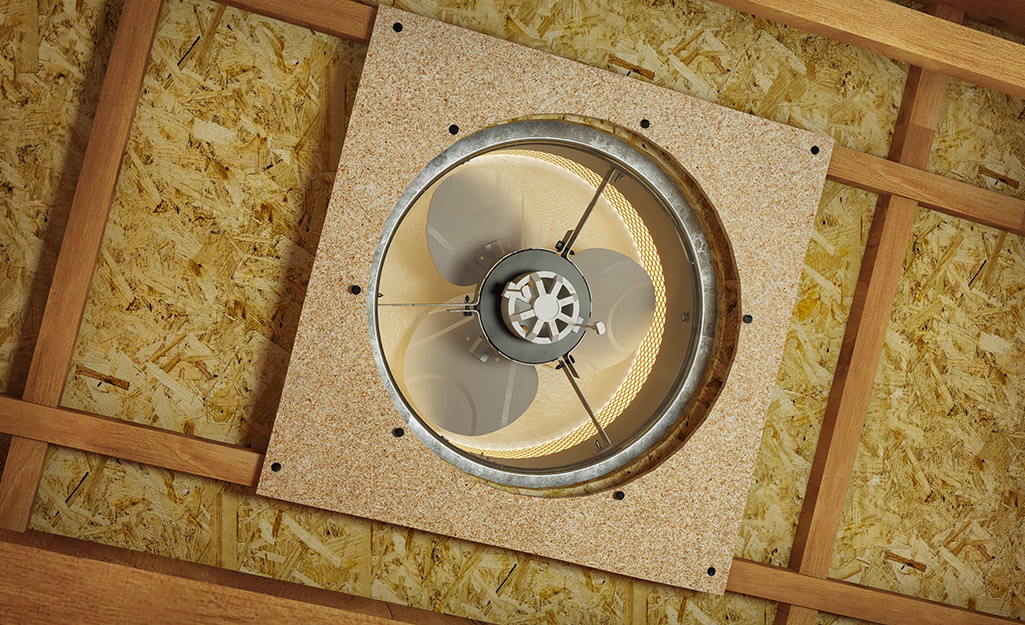 An electric fan installed in an attic.
