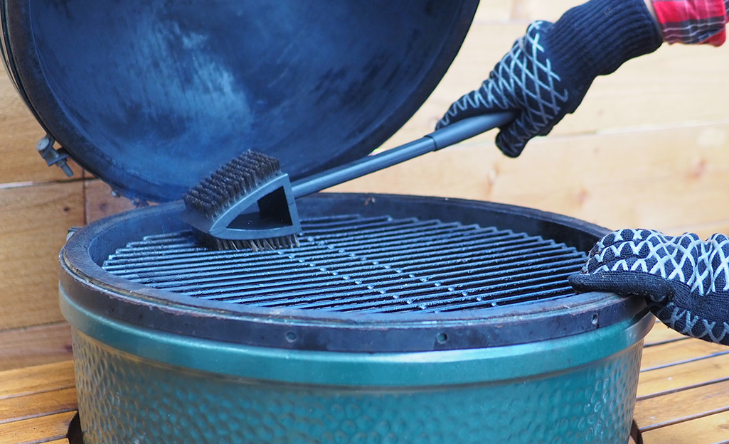 A scrubber cleaning grill grates.