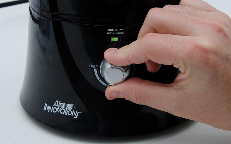 A person turning off a humidifier.