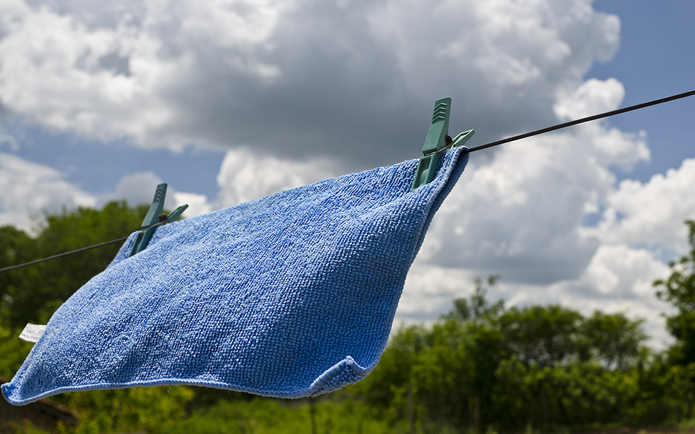 A microfiber cloth drying on a clothesline.