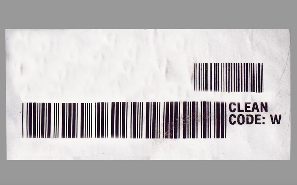 A tag displaying the care code for a microfiber couch.