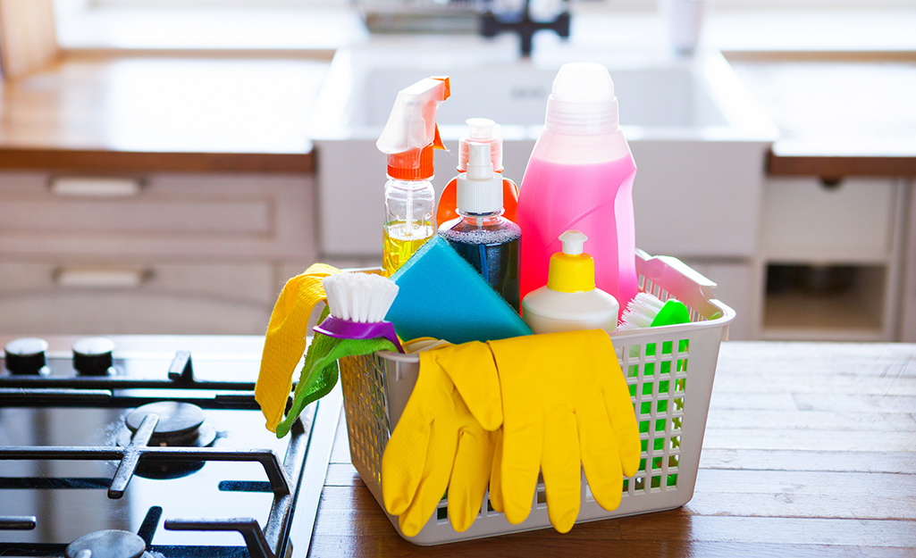 A basket of gloves and cleaning supplies.