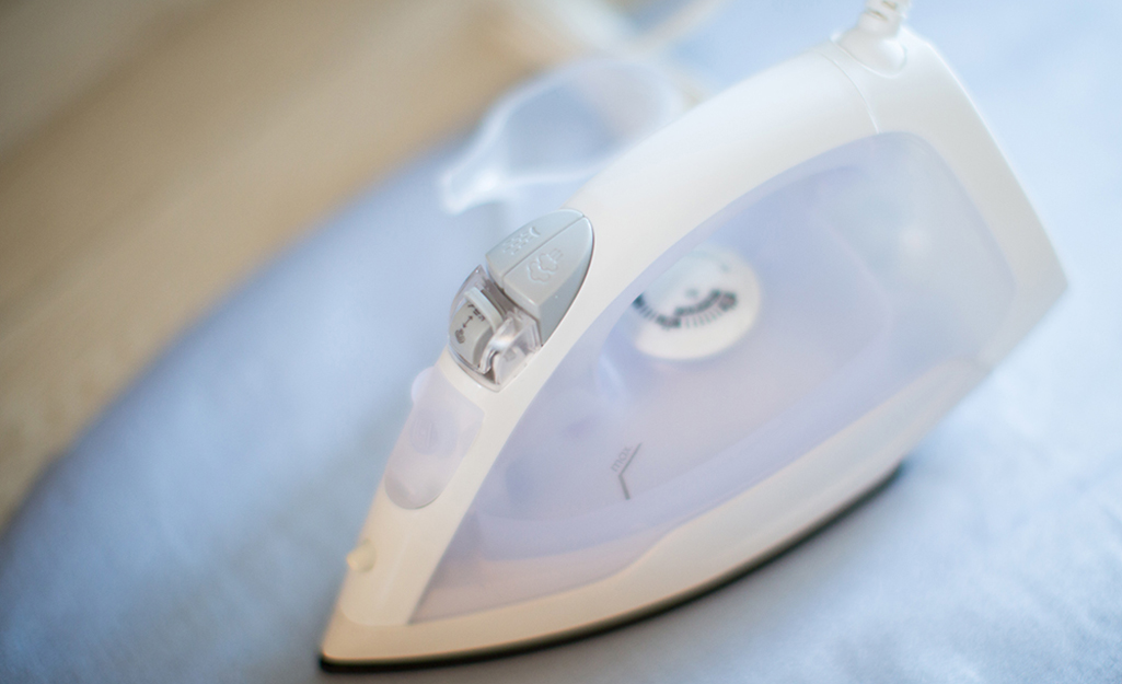 A clean iron sits on an ironing board.