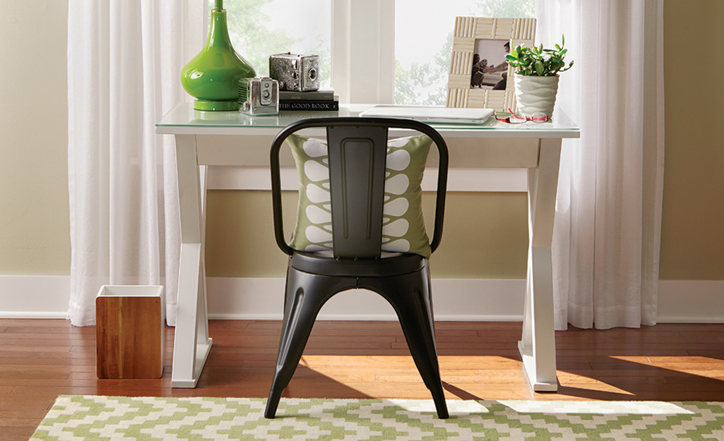 Clean baseboards can be seen behind a desk in front of a window. Clean baseboards can be seen behind a desk in front of a window.