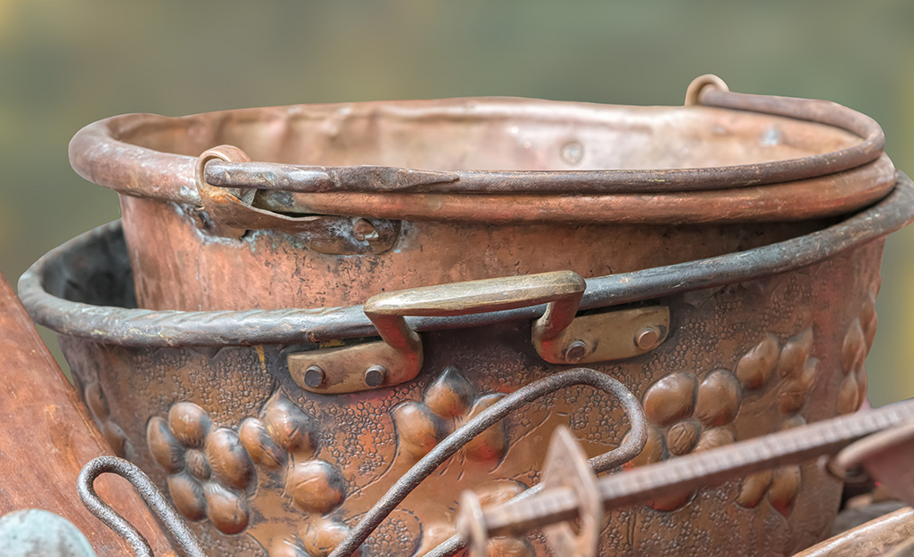 Copper tarnish appears on cookware.