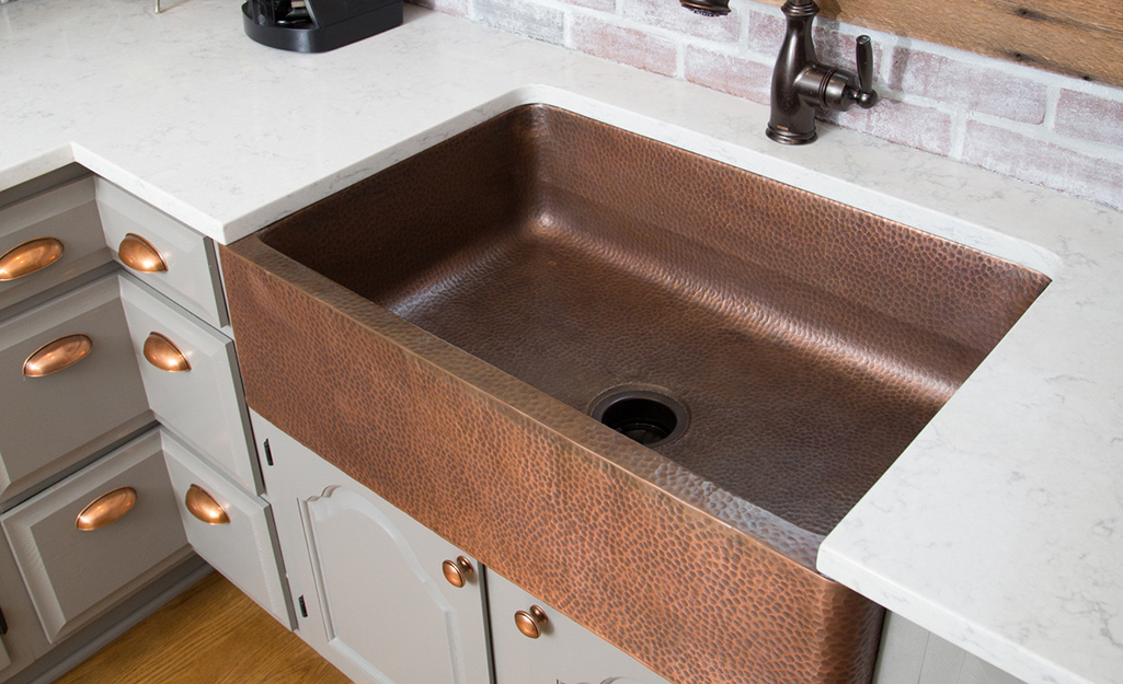 A copper sink in a kitchen.