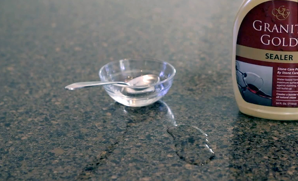 Someone doing a wetness test on a countertop. Someone doing a wetness test on a countertop.