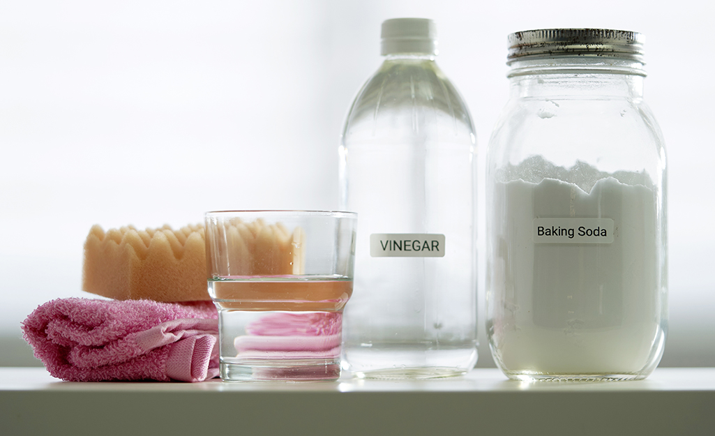 A jar of baking soda and a bottle of vinegar.