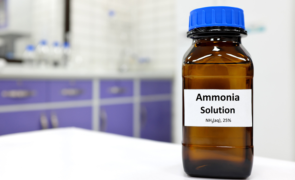 A bottle of ammonia solution on a counter.