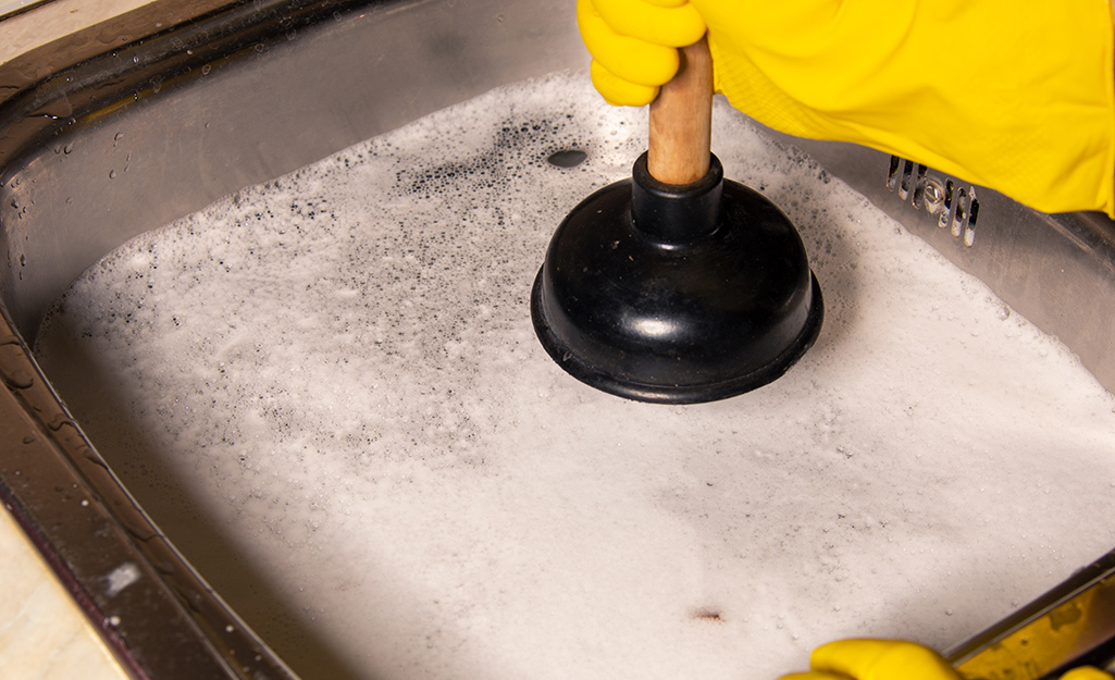 A clogged sink overflowing with water.