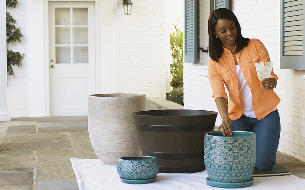 A woman selecting planters for a container garden.