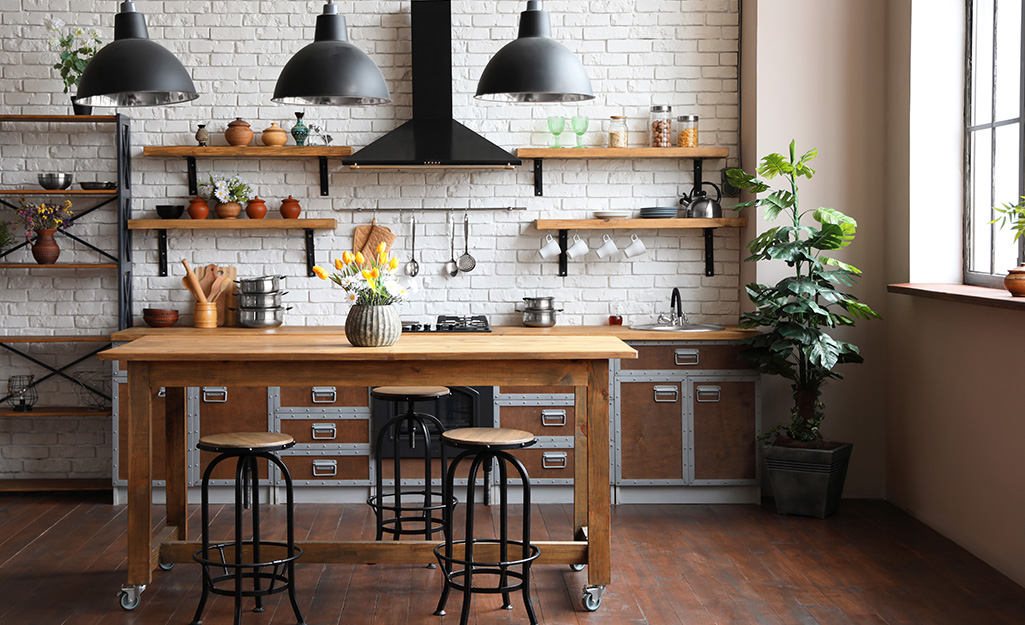 An industrial kitchen featuring open wall shelves with plenty of storage.