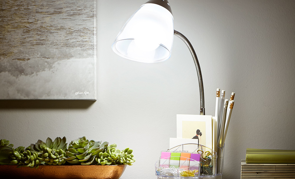 A desk lamp on a tabletop. A desk lamp on a tabletop.
