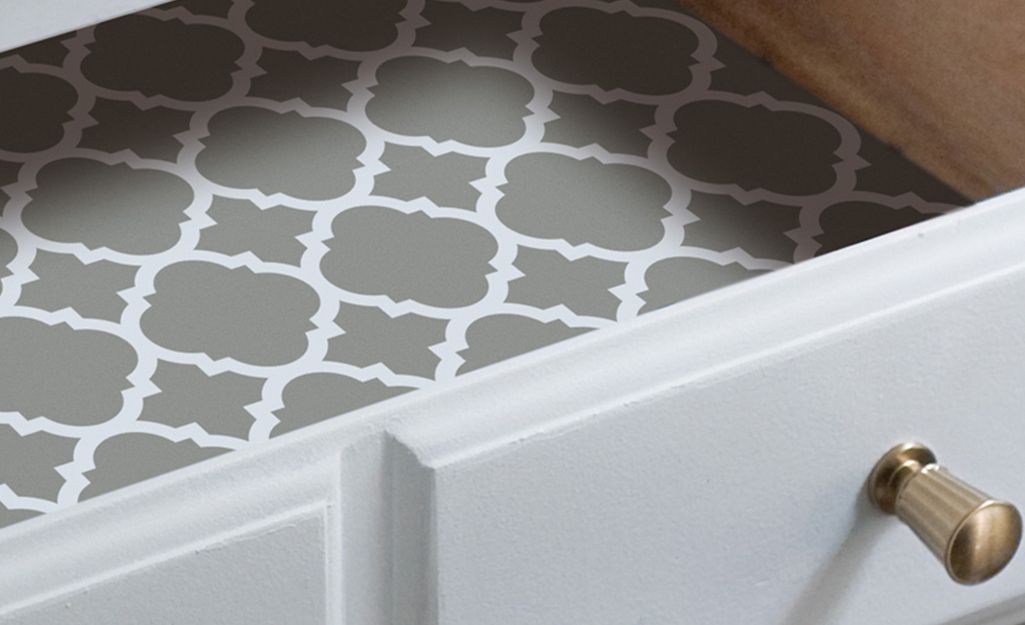 An open drawer revealing a decorative paper lining. An open drawer revealing a decorative paper lining.