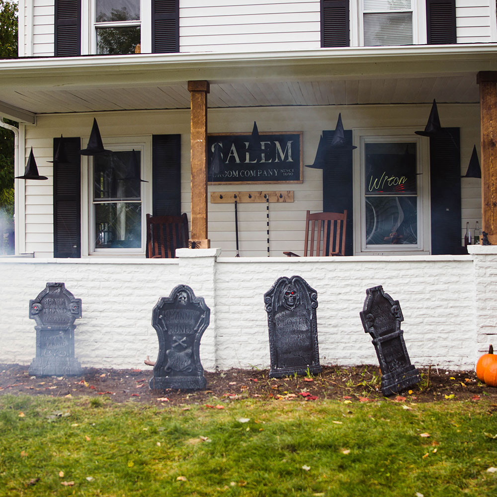 A spooky Halloween porch decorated with floating witch hats.