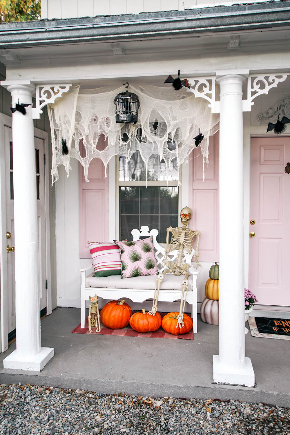 A porch with pumpkins and a skeleton sitting on a bench. A porch with pumpkins and a skeleton sitting on a bench.
