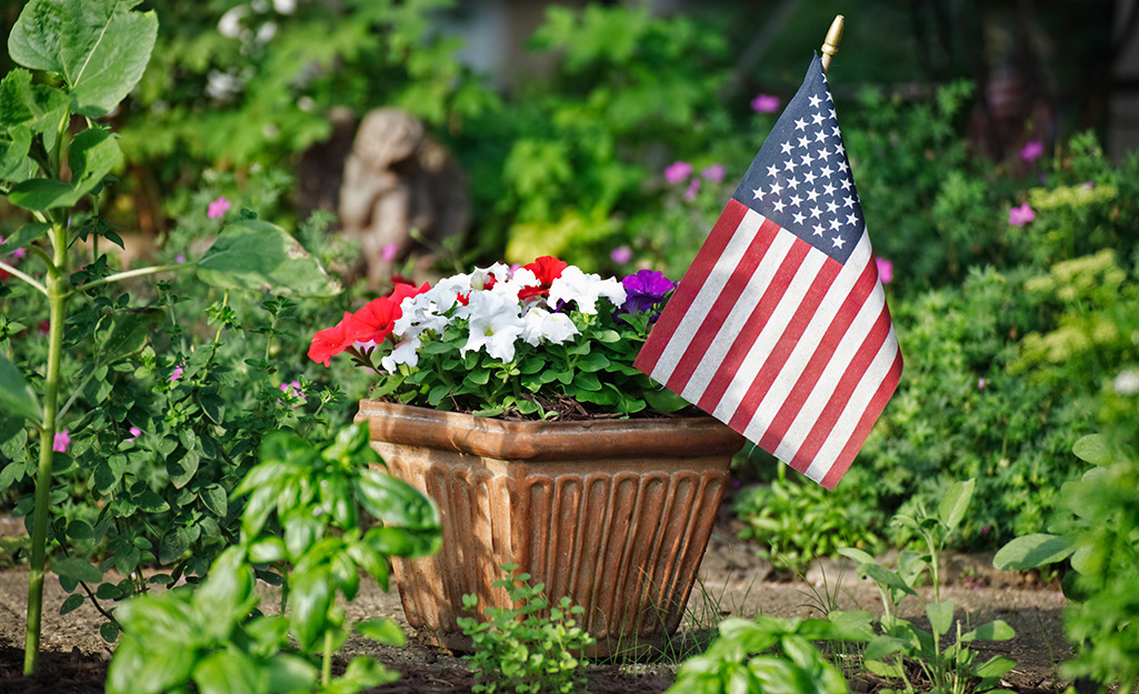 A flower planter with an American flag sticking out